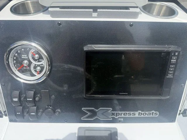 Slide: The Image of Dashboard of 2026 Xpress Boats H20B with tachometer and Garmin display. - 17