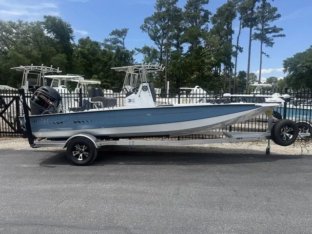 Slide: The Image of 2026 Xpress Boats H20B on trailer, blue, parked outdoors. - 2