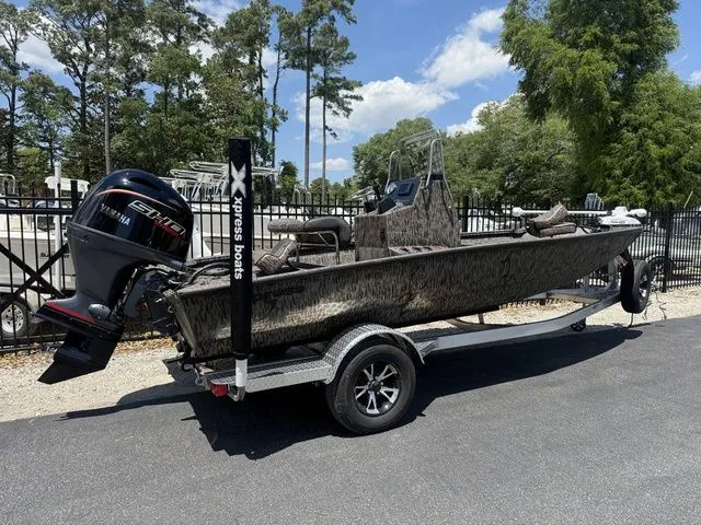 Slide: The Image of 2026 Xpress Boats H190B on trailer, parked outdoors. - 4