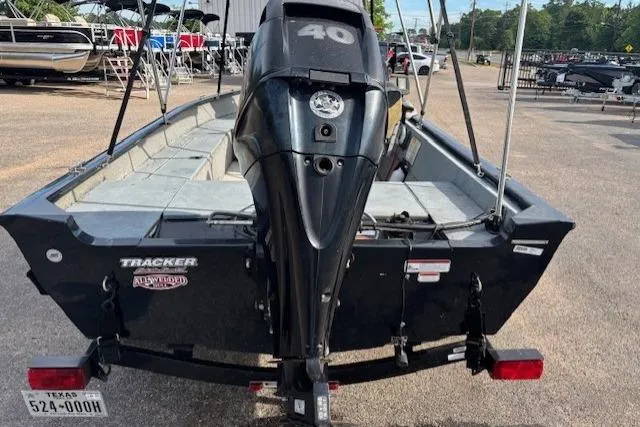 Slide: The Image of 2013 Tracker Super Guide V-16 SC boat with 40 HP motor, parked outdoors. - 4