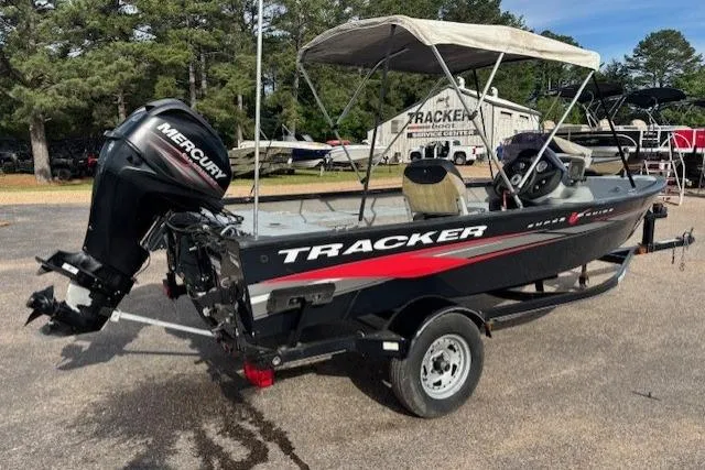 Slide: The Image of 2013 Tracker Super Guide V-16 SC boat with Mercury engine, parked outdoors. - 5