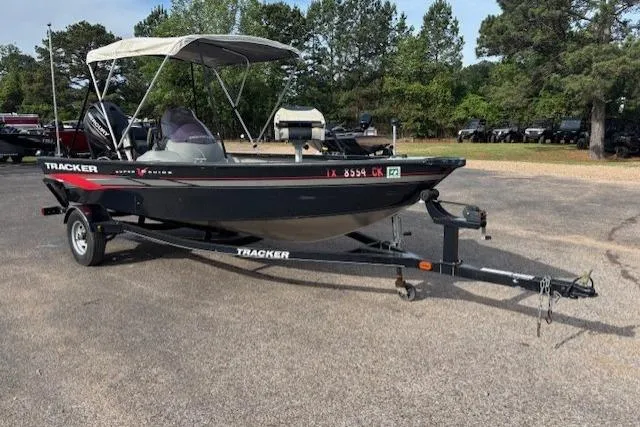 Slide: The Image of 2013 Tracker Super Guide V-16 SC boat on trailer, parked outdoors. - 6