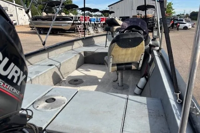 Slide: The Image of 2013 Tracker Super Guide V-16 SC boat interior with seating and Mercury engine. - 8
