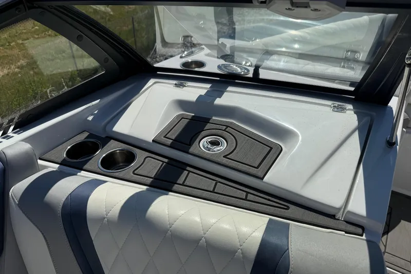Slide: The Image of Interior of 2022 Tigé 21ZX boat featuring cup holders and sleek design. - 13
