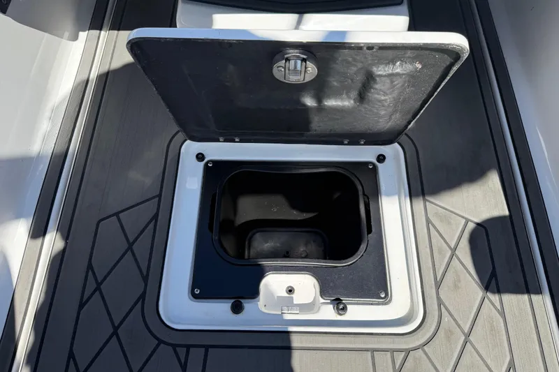 Slide: The Image of Open storage compartment on 2022 Tigé 21ZX boat deck. - 21