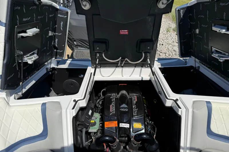 Slide: The Image of 2022 Tigé 21ZX boat engine compartment with open hatches, showcasing interior details. - 24