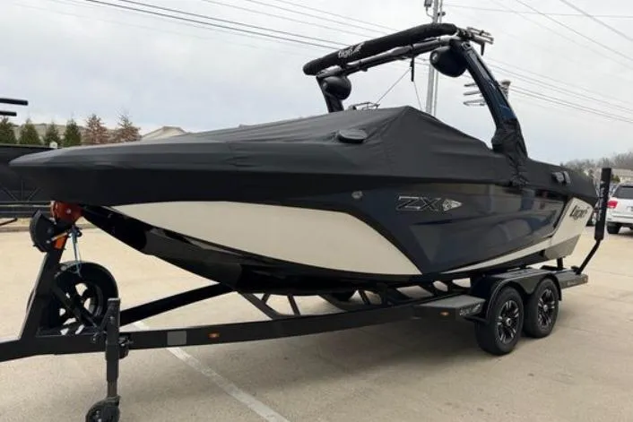 Slide: The Image of 2022 Tigé 21ZX boat on trailer, covered, parked outdoors. - 3