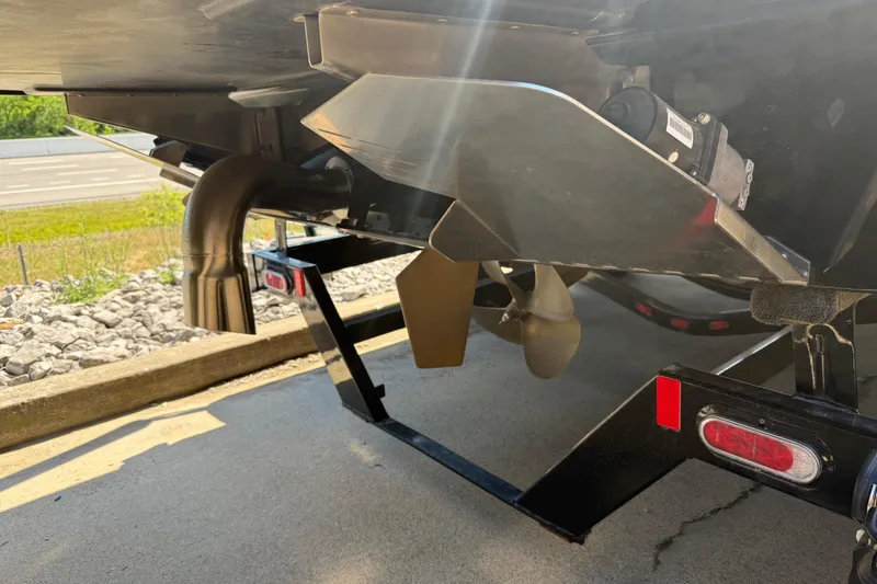 Slide: The Image of 2022 Tigé 21ZX boat underside showing propeller and exhaust system in sunlight. - 30