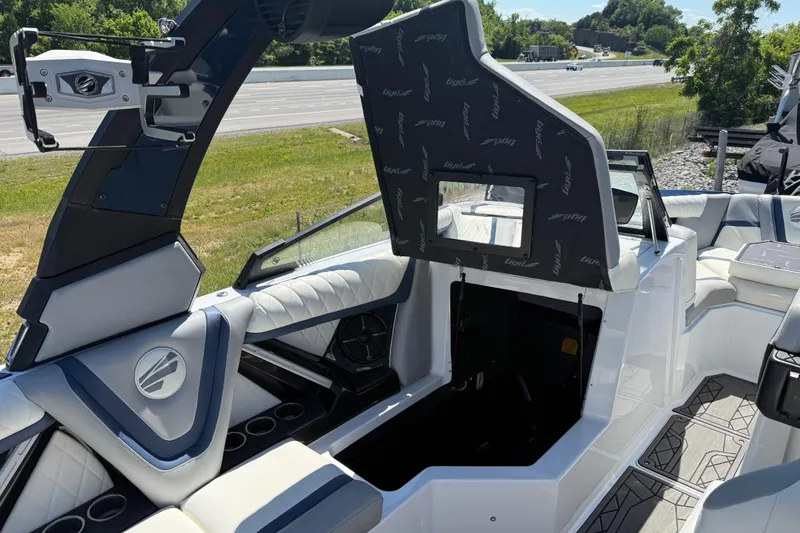 Slide: The Image of 2022 Tigé 21ZX boat interior with open storage compartment and sleek seating design. - 9