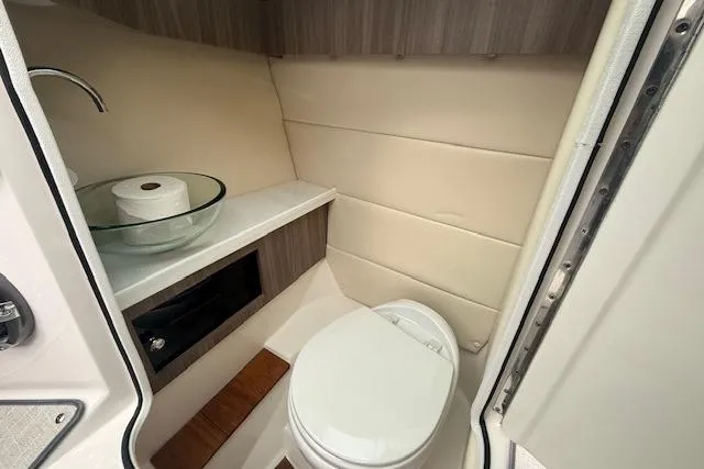Slide: The Image of 2021 Regal 2800 Bowrider boat bathroom with modern sink and toilet. - 12