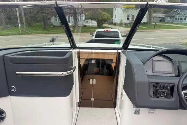 Slide: The Image of 2021 Regal 2800 Bowrider interior view with dashboard and open cabin door. - 14