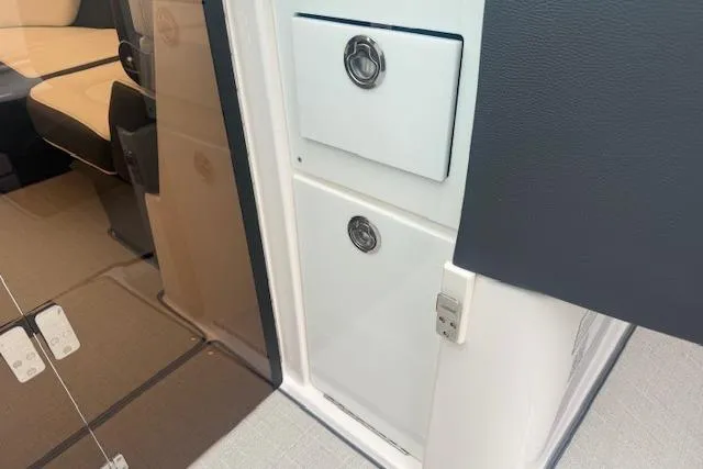 Slide: The Image of 2021 Regal 2800 Bowrider interior showing storage compartments and seating area. - 15