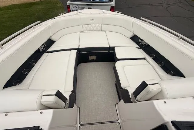 Slide: The Image of 2021 Regal 2800 Bowrider boat with spacious white seating and sleek design. - 18
