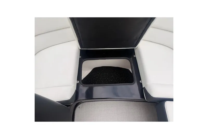 Slide: The Image of 2021 Regal 2800 Bowrider interior storage compartment with white seating and black accents. - 20