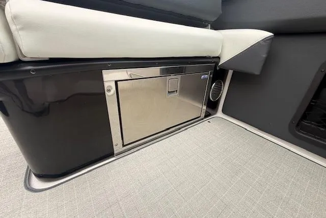 Slide: The Image of 2021 Regal 2800 Bowrider interior with stainless steel storage compartment and cushioned seating. - 25