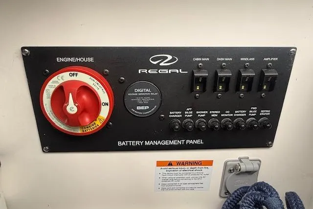 Slide: The Image of Battery management panel of 2021 Regal 2800 Bowrider boat with switches and warning label. - 30