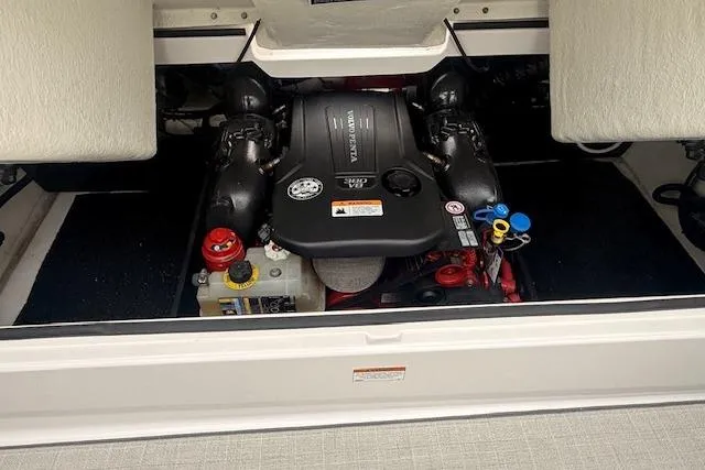 Slide: The Image of Engine compartment of a 2021 Regal 2800 Bowrider boat, showcasing the engine and components. - 34
