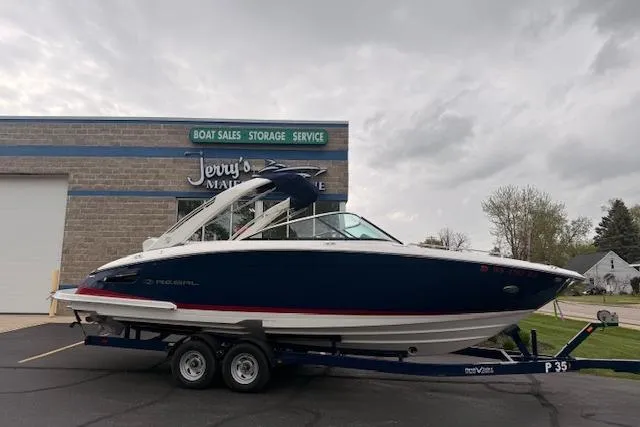 Slide: The Image of 2021 Regal 2800 Bowrider boat on trailer at dealership, overcast sky. - 37