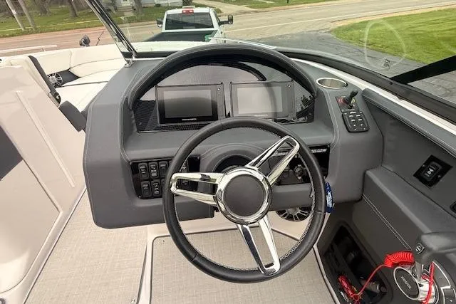 Slide: The Image of 2021 Regal 2800 Bowrider dashboard with steering wheel and control panels. - 6