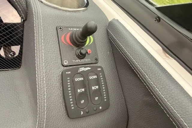 Slide: The Image of Control panel of 2021 Regal 2800 Bowrider boat featuring thruster and trim controls. - 7