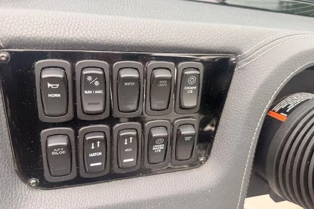 Slide: The Image of Dashboard controls of a 2021 Regal 2800 Bowrider boat, featuring various function switches. - 8