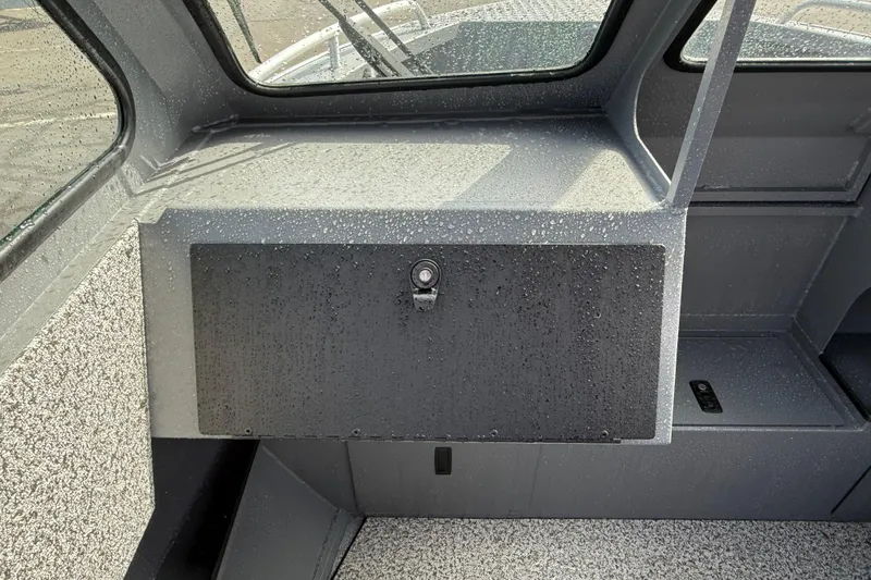 Slide: The Image of Interior view of 2026 Alumaweld Stryker X202 boat, featuring sleek design and water droplets. - 10