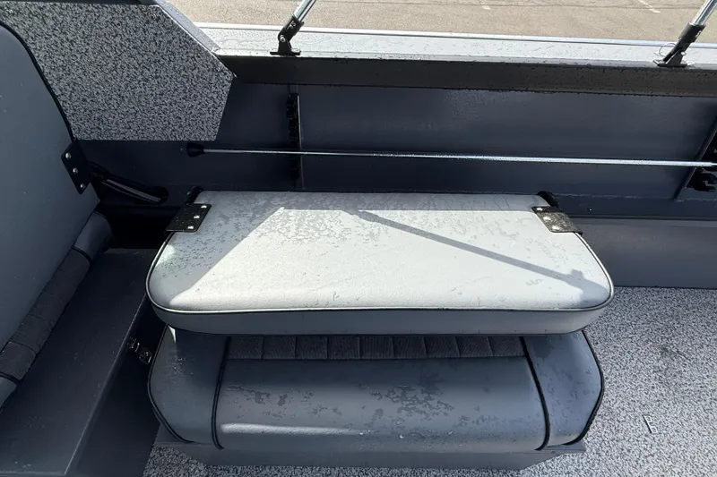 Slide: The Image of 2026 Alumaweld Stryker X202 boat interior with gray seating and textured flooring. - 13