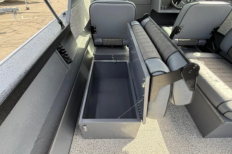 Slide: The Image of 2026 Alumaweld Stryker X202 boat interior with open storage compartment and seating. - 16