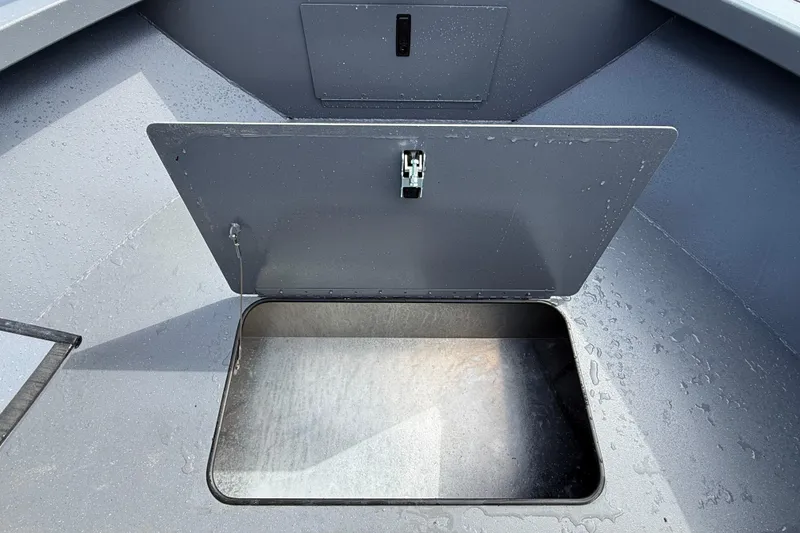 Slide: The Image of Open storage compartment on 2026 Alumaweld Stryker X202 boat, showcasing interior space. - 23