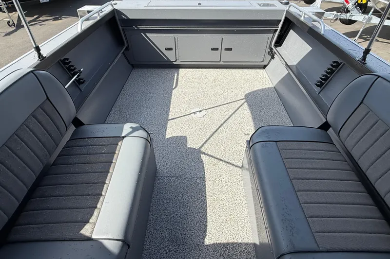 Slide: The Image of 2026 Alumaweld Stryker X202 boat interior with gray seating and spacious deck. - 25