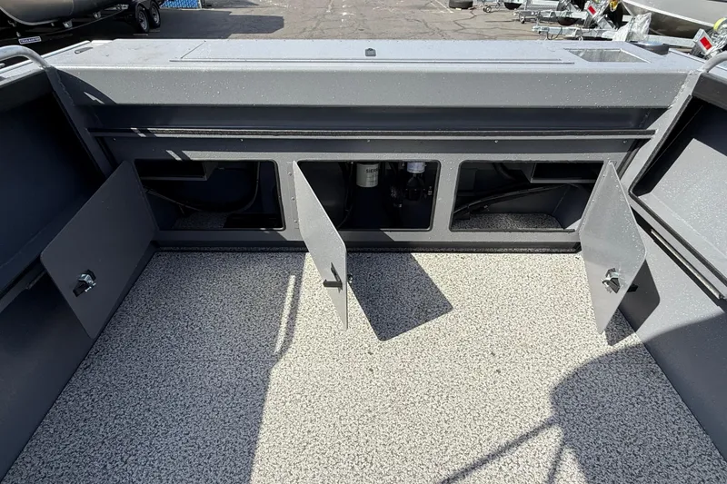 Slide: The Image of 2026 Alumaweld Stryker X202 boat interior storage compartments with open doors. - 27