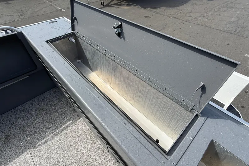 Slide: The Image of Open storage compartment on 2026 Alumaweld Stryker X202 boat, showcasing interior space. - 29
