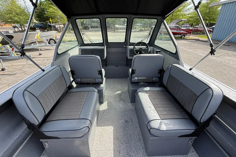 Slide: The Image of 2026 Alumaweld Stryker X202 boat interior with gray seating and steering console. - 5