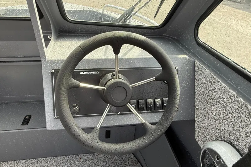 Slide: The Image of Steering wheel of 2026 Alumaweld Stryker X202 boat, featuring sleek design and controls. - 8