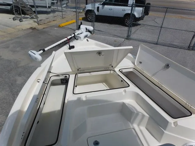 Slide: The Image of 2017 Skeeter SX210 boat with open storage compartments and trolling motor. - 11