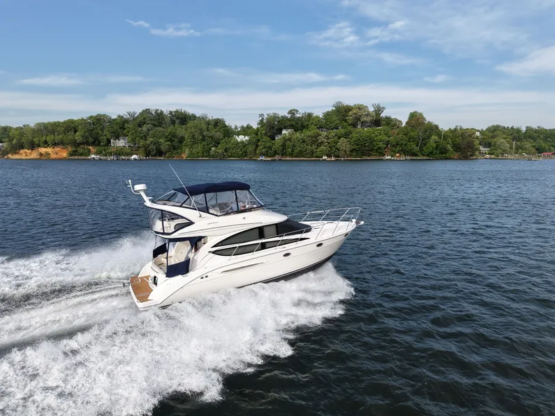 The Image of 2008 Meridian 391 Sedan cruising on a serene lake with wooded shoreline. - 0