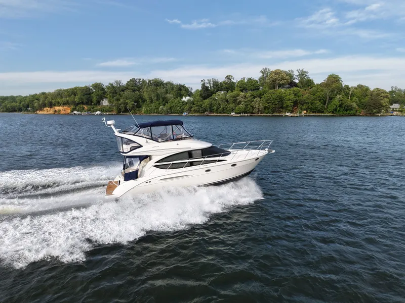 Slide: The Image of 2008 Meridian 391 Sedan yacht cruising on a serene lake. - 2