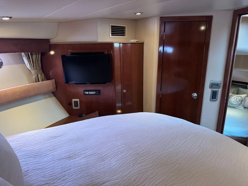 Slide: The Image of Interior of a 2008 Meridian 391 Sedan yacht with TV and wooden doors. - 29