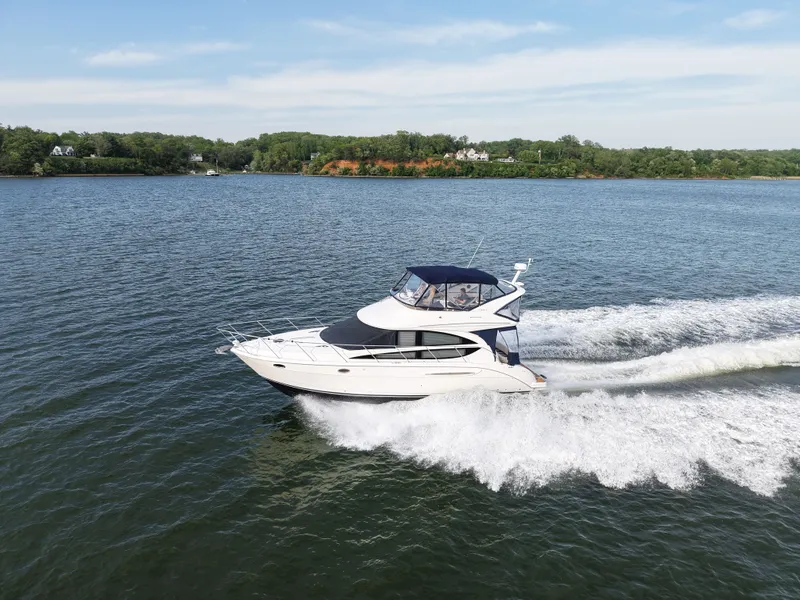 Slide: The Image of 2008 Meridian 391 Sedan yacht cruising on a serene lake. - 4