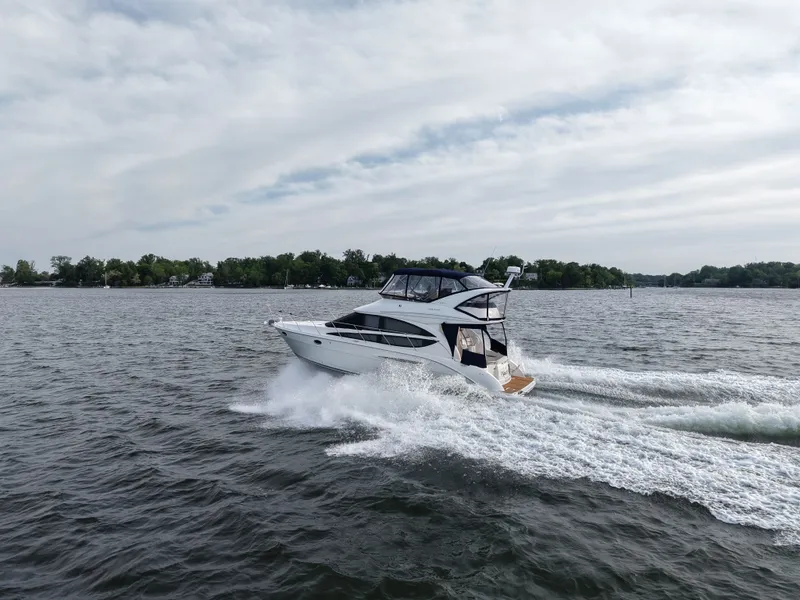Slide: The Image of 2008 Meridian 391 Sedan yacht cruising on open water. - 5