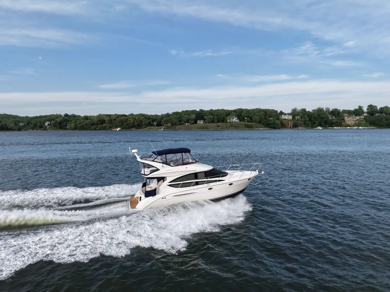 Slide: The Image of 2008 Meridian 391 Sedan yacht cruising on calm waters. - 9