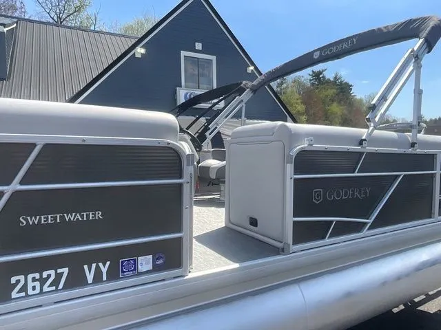 Slide: The Image of 2023 Godfrey Pontoons Xperience 2086 BFX in front of a blue building. - 6