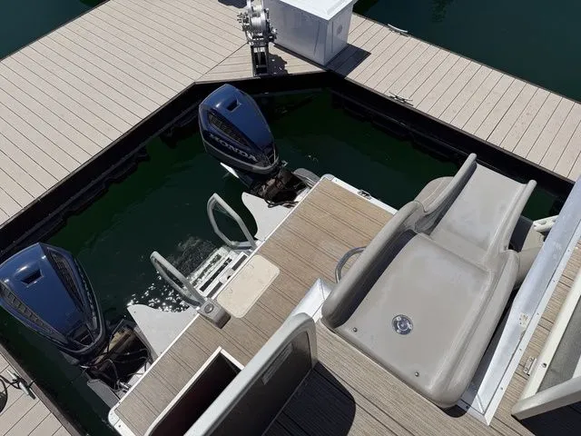 Slide: The Image of Premier Escalante 310 DL 2022 with dual outboard motors at dock. - 9