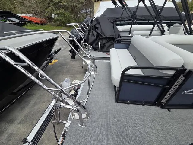 Slide: The Image of Crest Conquest SE 220 Cruise Tri-Toon with gray seating and stainless steel railings. - 16