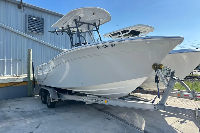 The Image of 2021 Sea Fox 228 Commander boat on trailer, parked outdoors near a building. - 1
