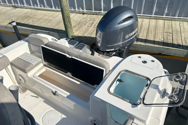 Slide: The Image of 2021 Sea Fox 228 Commander boat with Yamaha engine, featuring seating and storage compartments. - 14