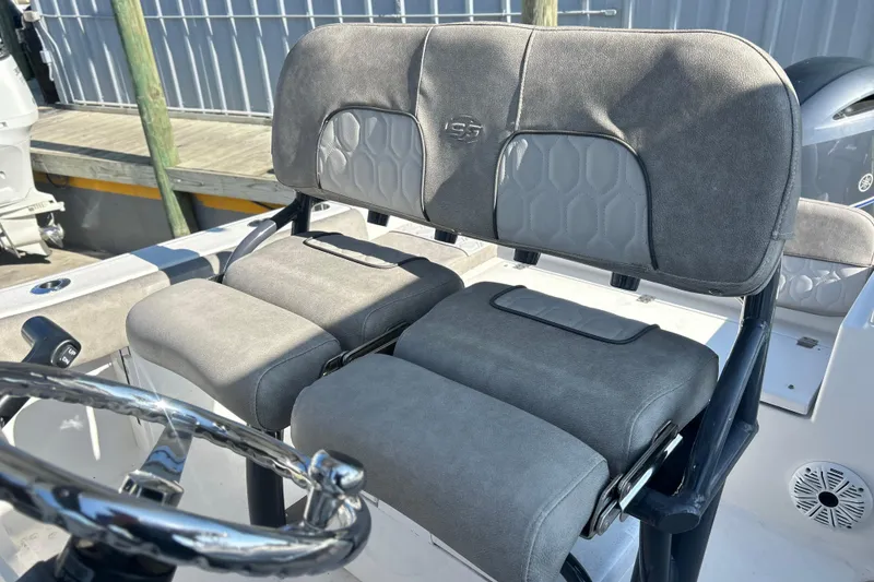 Slide: The Image of 2021 Sea Fox 228 Commander boat seating with steering wheel, featuring gray upholstery. - 6
