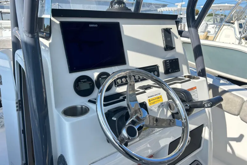 Slide: The Image of 2021 Sea Fox 228 Commander boat dashboard with steering wheel and navigation controls. - 7