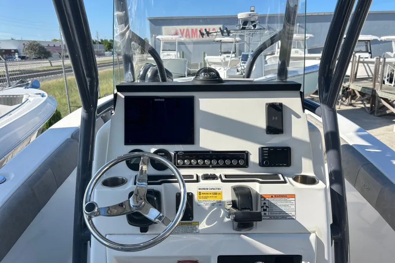 Slide: The Image of 2021 Sea Fox 228 Commander boat dashboard with steering wheel and navigation controls. - 8