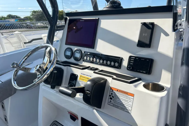 Slide: The Image of 2021 Sea Fox 228 Commander dashboard with steering wheel, controls, and navigation equipment. - 9